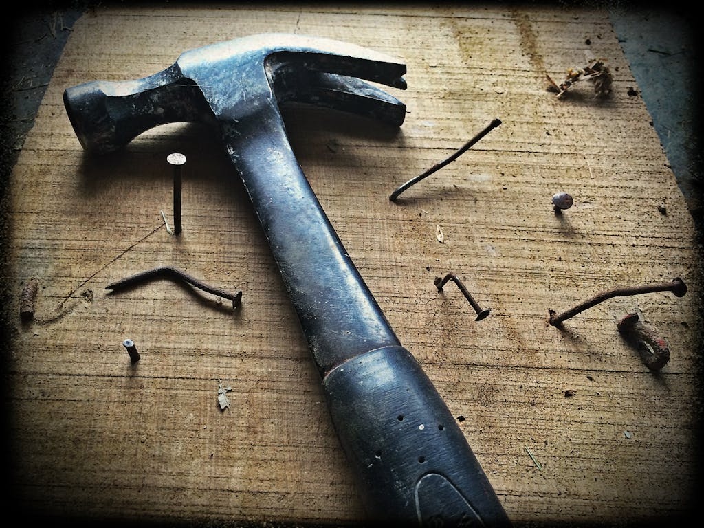 Black Claw Hammer on Brown Wooden Plank | 5 ways to spiritually cleanse your home - nailing it down