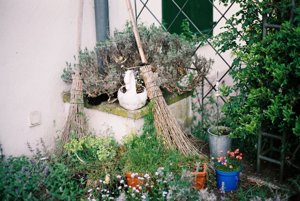 Five Ways to spiritually Cleanse your home | An image of Two Brooms Near Fence and Wall